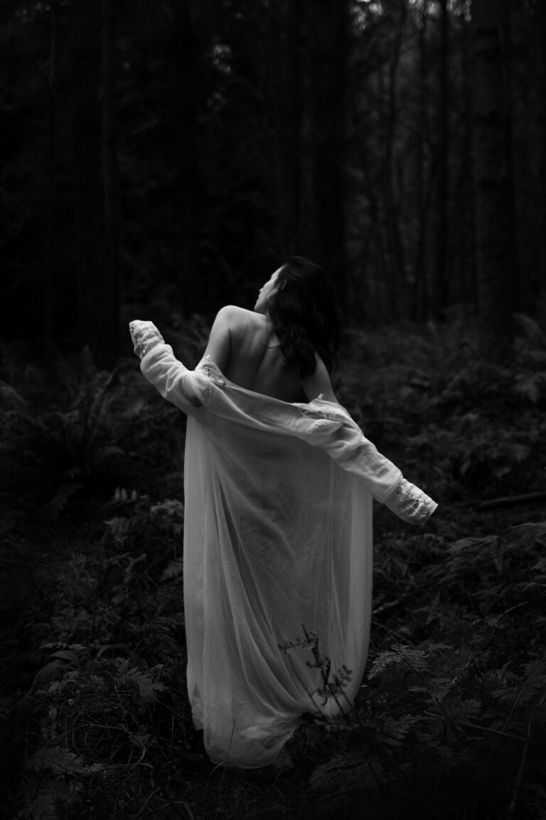 Amazing photograph of a woman in forest, sensual tones and nudity.