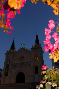 Beautiful photograph of the Church in Alhourin el grande. The picture is taken at twilight, using the camera flash to light the flowers in the foreground.