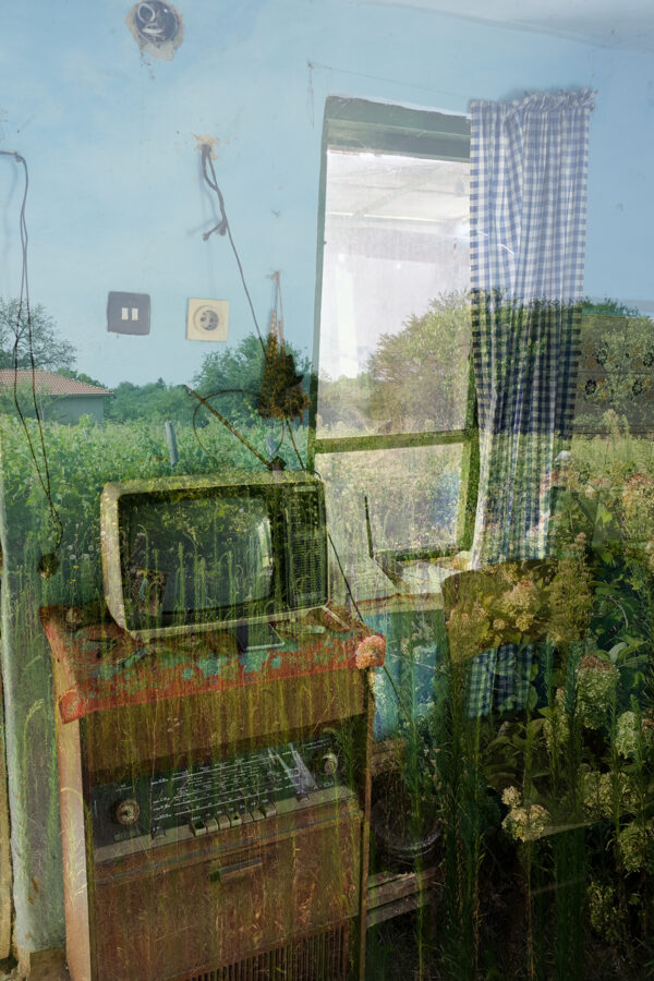 Interesting photo of a tv cabinet in the garden, created with a double exposure technique.